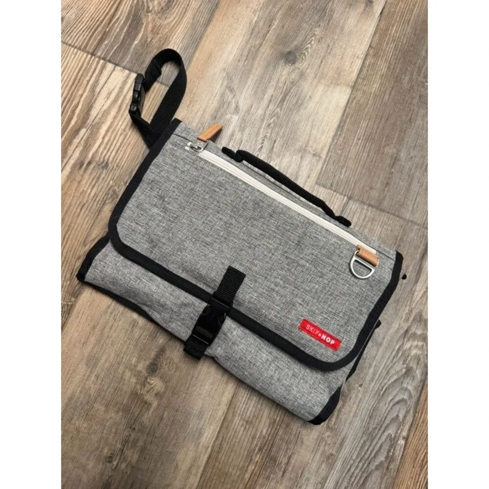Travel diaper clutch and changing pad